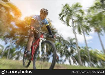 Sportsman cycling the bicycle from highland, selective focus, radial blur, Sport concept