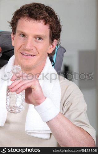 Sportsman drinking a bottle of water