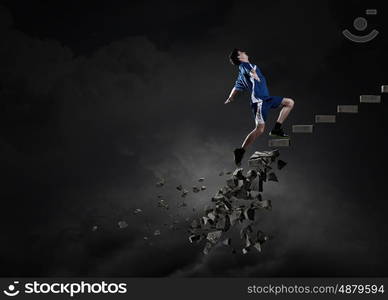 Sportsman overcoming challenges. Sports active man running on stone collapsing ladder