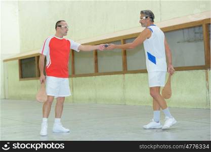 Sportsman passing ball to colleague