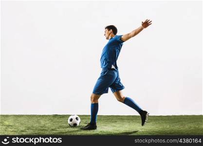 sportsman running kicking ball
