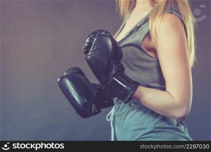 Sportsmanship fairplay and strong body. Young woman fighting boxing. Girl wearing black punch gloves. Sport and fitness, power, exercising, on gray. Boxer girl exercise with boxing gloves.