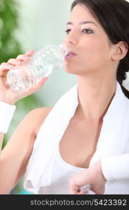 Sportswoman drinking water