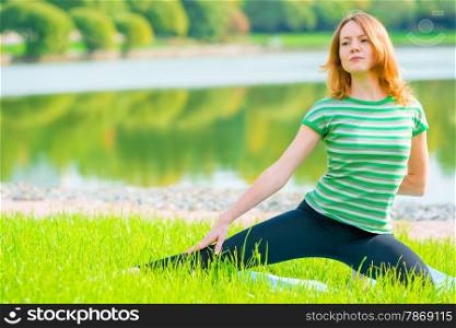 sportswomen do exercises on the lush grass in the park