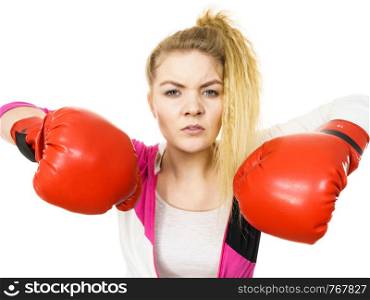 Sporty angry and agressive woman wearing red boxing gloves, fighting. Studio shot on white background.. Angry woman wearing boxing gloves