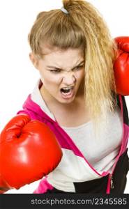 Sporty angry determined woman wearing red boxing gloves, fighting and screaming. Studio shot on white background.. Angry woman wearing boxing gloves