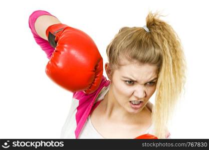 Sporty angry determined woman wearing red boxing gloves, fighting. Studio shot on white background.. Angry woman wearing boxing gloves