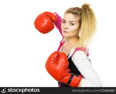 Sporty confident woman wearing red boxing gloves, fighting. Studio shot on white background.. Woman wearing boxing gloves