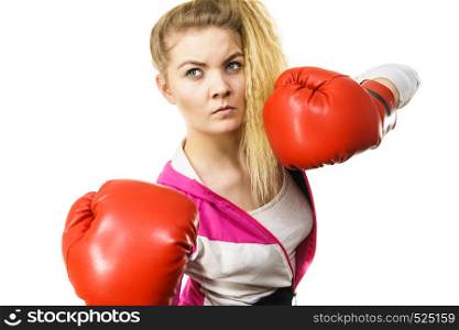 Sporty confident woman wearing red boxing gloves, fighting. Studio shot on white background.. Woman wearing boxing gloves