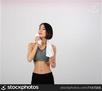 sporty fitness woman in sportswear with towel on white background. healthy sport lifestyle