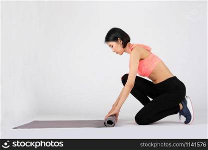 sporty fitness woman in sportswear with yoga mat on white background. healthy sport lifestyle