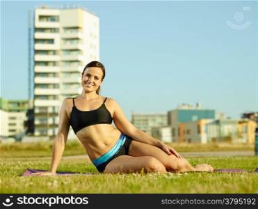 Sporty fitness woman in the park early in the morning, urban background