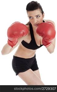 Sporty girl in boxing gloves punching over white background