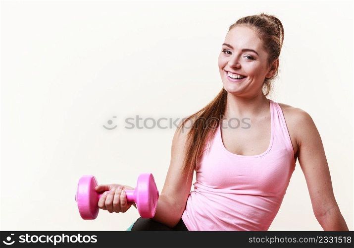 Sporty girl lifting weights. Female gymnastic exercising with dumbbell. Health fitness workout concept. . Sporty girl lifting weights. 