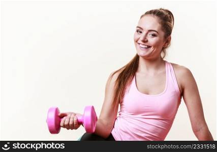 Sporty girl lifting weights. Female gymnastic exercising with dumbbell. Health fitness workout concept. . Sporty girl lifting weights. 