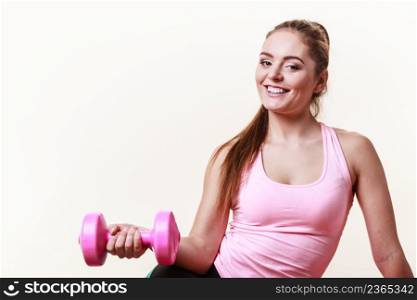 Sporty girl lifting weights. Female gymnastic exercising with dumbbell. Health fitness workout concept. . Sporty girl lifting weights.