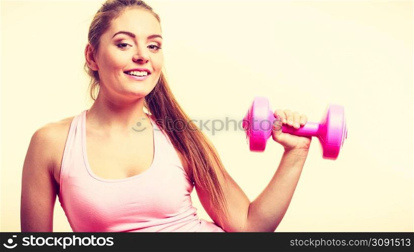 Sporty girl lifting weights. Female gymnastic exercising with dumbbell. Health fitness workout concept. . Sporty girl lifting weights.