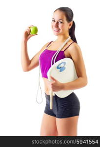 Sporty girl with apple and scales isolated