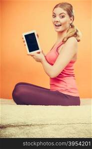 Sporty girl with pc tablet. Blank screen copyspace. Sporty fitness girl holding tablet computer with blank screen showing copyspace. Happy smiling woman advertising new modern technology.