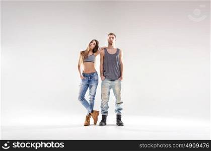 Sporty hip-hop couple isolated over the bright background