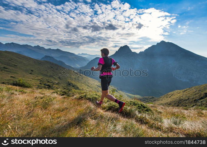 Sporty mountain man rides in trail during endurance training