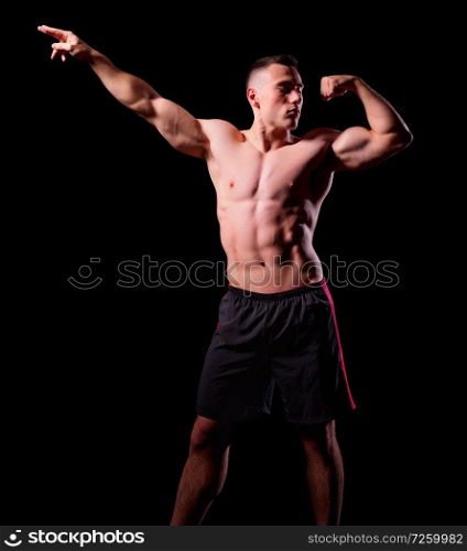 Sporty muscular man isolated on black