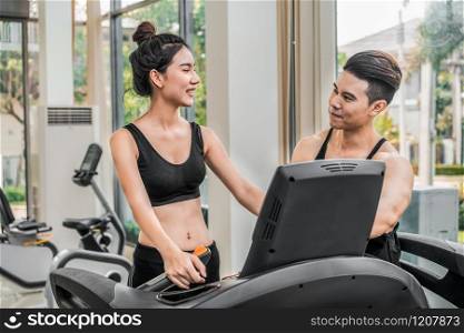 Sporty runner running on treadmill in fitness gym. Healthy lifestyle concept.. Sporty runner running on treadmill in fitness gym.