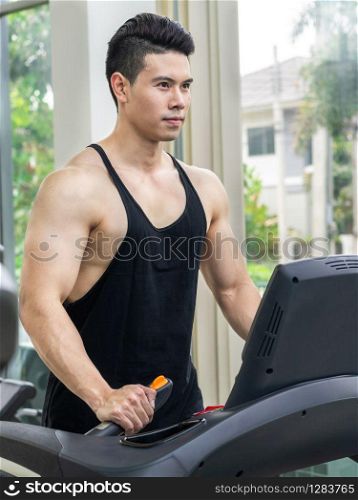 Sporty runner running on treadmill in fitness gym. Healthy lifestyle concept.. Sporty runner running on treadmill in fitness gym.