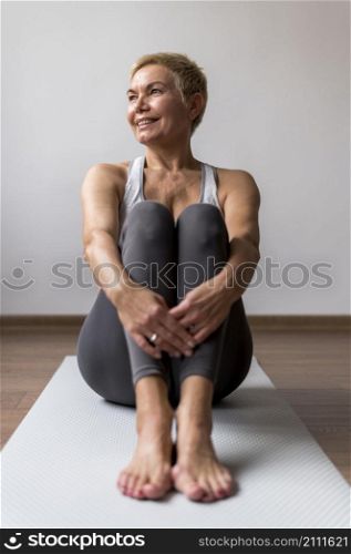 sporty senior woman with short hair sitting