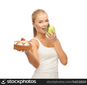 sporty woman eating apple and holding cake