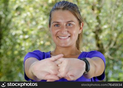 sporty woman enjoying stretching arms and body