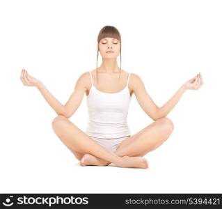 sporty woman in cotton underwear practicing yoga lotus pose