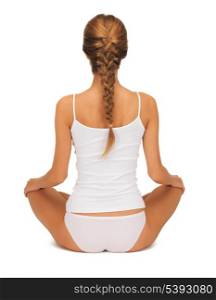 sporty woman in cotton undrewear practicing yoga lotus pose