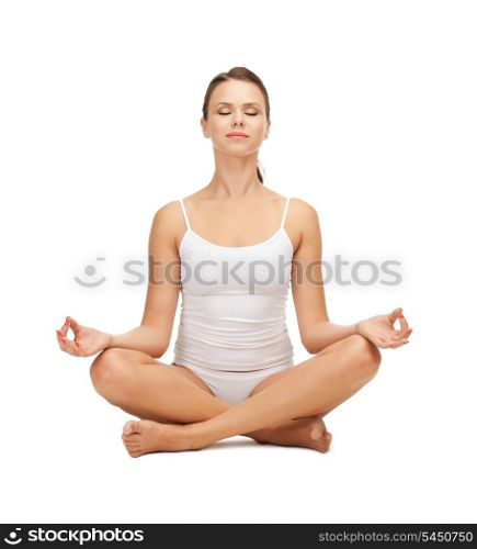 sporty woman in cotton undrewear practicing yoga lotus pose