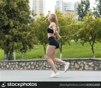 sporty woman jumping skipping rope