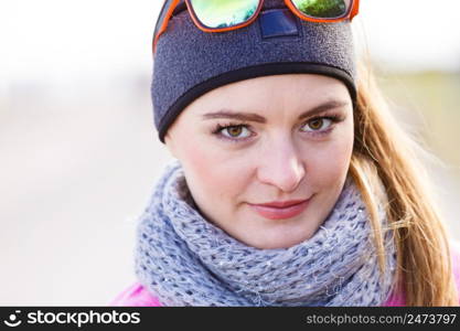 Sporty woman portrait outdoors. Fitness girl wearing warm sporty clothes in cold day. Fitness girl wearing warm sporty clothes in cold day