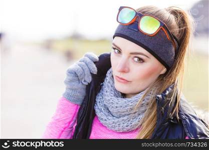 Sporty woman portrait outdoors. Fitness girl wearing warm sporty clothes in cold day. Fitness girl wearing warm sporty clothes in cold day