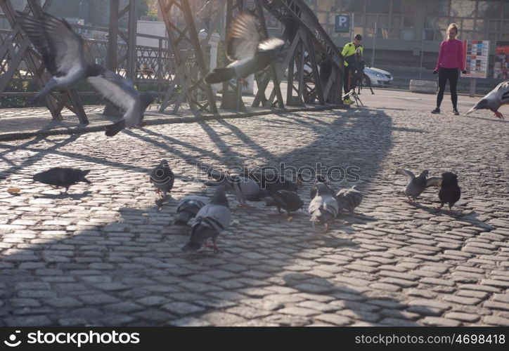 sporty woman running on sidewalk at early morning jogging with city sunrise scene in background