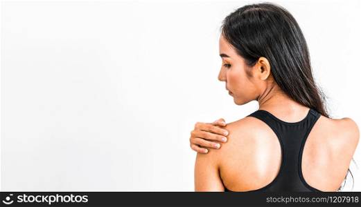 Sporty woman touching shoulder in fitness gym. Healthy lifestyle concept.