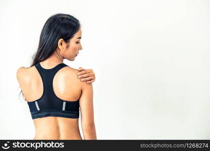 Sporty woman touching shoulder in fitness gym. Healthy lifestyle concept.