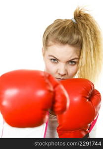 Sporty woman wearing red boxing gloves, fighting. Studio shot on white background.. Woman wearing boxing gloves