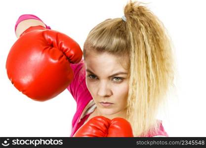 Sporty woman wearing red boxing gloves, fighting. Studio shot on white background.. Woman wearing boxing gloves