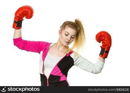 Sporty woman wearing red boxing gloves, winning fight, being motivated feeling relief and happiness. Studio shot on white background.. Woman winner wearing boxing gloves