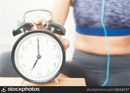 Sporty woman with alarm clock, Start up, Healthy concept