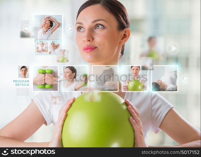 Sporty woman working out using modern virtual interface. Online fitness trainer concept