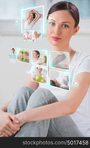 Sporty woman working out using modern virtual interface. Online fitness trainer concept