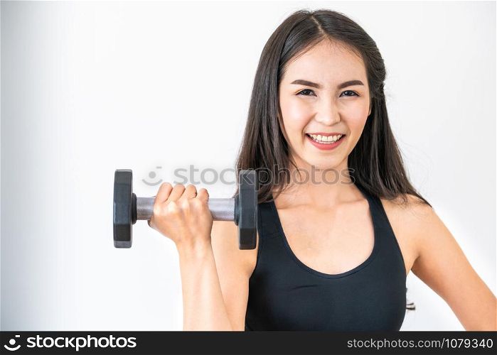 Sporty woman workout with dumbbell on clear background. Healthy lifestyle and exercising.
