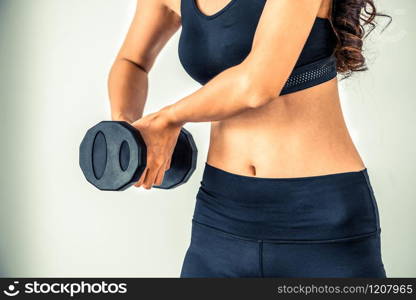 Sporty woman workout with dumbbell on clear background. Healthy lifestyle and exercising.