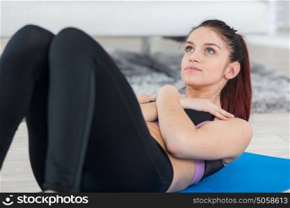 sporty young woman doing sits-up