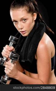 Sporty young woman exercising lifting weights with towel behind neck